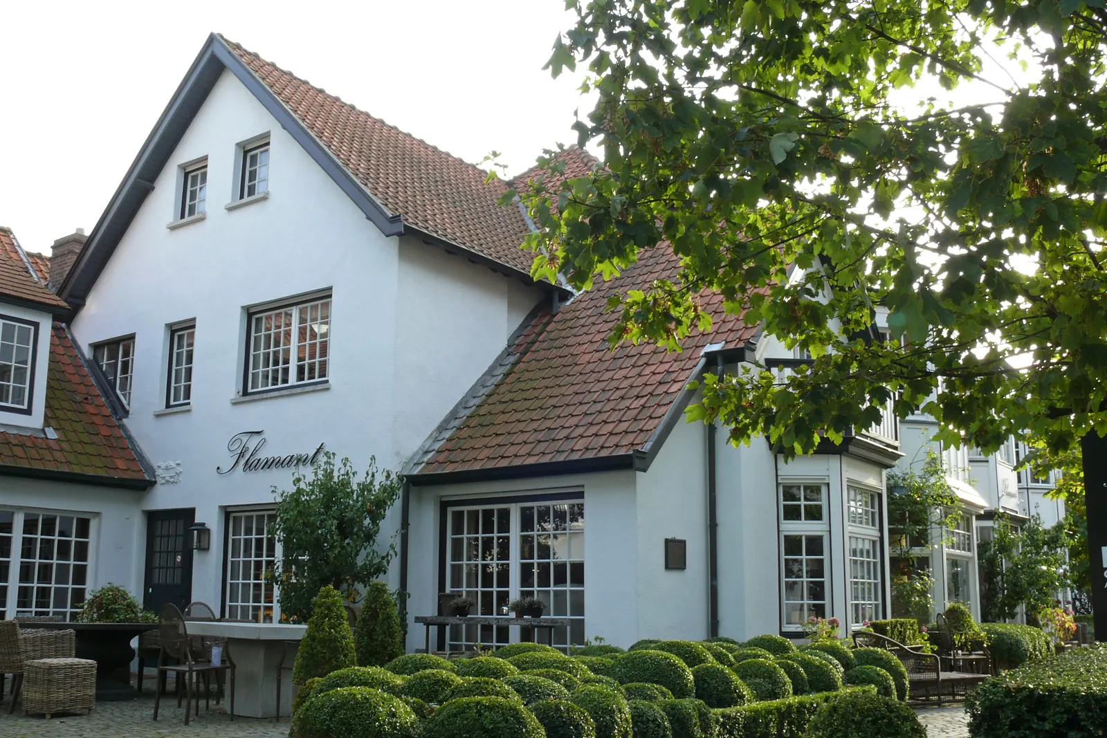 Wäiss Cottagefassade mat rouden Diecher a Buxbeem an der Kustlaan zu Knokke (Foto vun 2012)